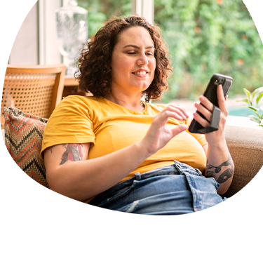 African American woman exploring fertility savings options on computer while talking on the phone