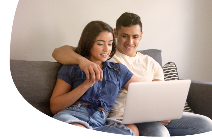 same sex female couple looking at phone together and exploring their options for fertility savings